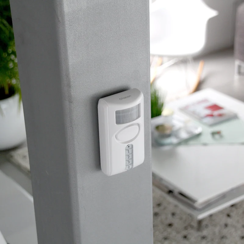 Motion detector with integrated alarm and keypad