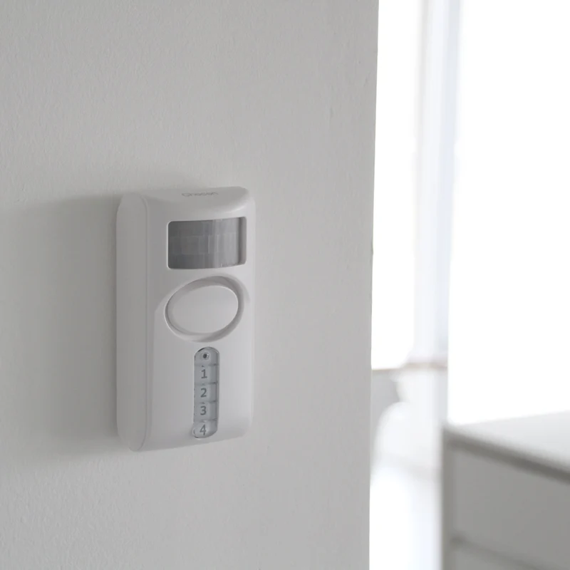 Motion detector with integrated alarm and keypad